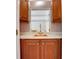 Wet bar featuring a copper sink, glass shelving, and wooden cabinetry offers a stylish space for drinks and entertaining at 1020 Riverside Rd, Roswell, GA 30076