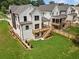 Aerial view of the home's deck, patio, and backyard with a wooden fence and mature trees at 267 Green Hill Rd, Sandy Springs, GA 30042