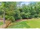 Large backyard showcasing a grassy lawn and mature trees at 267 Green Hill Rd, Sandy Springs, GA 30042