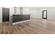 Basement area featuring hardwood floors, modern black door, and bar with storage at 267 Green Hill Rd, Sandy Springs, GA 30042