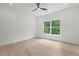 Inviting bedroom bathed in natural light with a ceiling fan and tree views through a double window at 267 Green Hill Rd, Sandy Springs, GA 30042