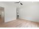 Bright bedroom featuring a ceiling fan, fresh white paint, and light hardwood flooring at 267 Green Hill Rd, Sandy Springs, GA 30042