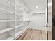 Walk-in closet with ample shelving and laminate floors, offering plenty of storage space at 267 Green Hill Rd, Sandy Springs, GA 30042