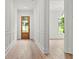 Bright entryway showcasing light wood floors, white wainscoting, and a charming wood door at 267 Green Hill Rd, Sandy Springs, GA 30042