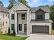 Charming new construction home featuring painted brick, black accents, and a two-car garage at 267 Green Hill Rd, Sandy Springs, GA 30042