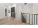 Hallway featuring a staircase, modern chandelier, and wood floors at 267 Green Hill Rd, Sandy Springs, GA 30042
