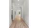 Long hallway with light wood floors, white wainscoting and molding, and recessed lighting at 267 Green Hill Rd, Sandy Springs, GA 30042