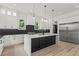 Stylish kitchen offers an island, modern lighting, white cabinets, and stainless steel appliances at 267 Green Hill Rd, Sandy Springs, GA 30042