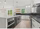 Bright kitchen boasts an island, pendant lighting, and a stainless steel oven and cooktop at 267 Green Hill Rd, Sandy Springs, GA 30042
