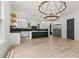 Spacious kitchen with a striking chandelier, stainless steel refrigerator, and granite countertops at 267 Green Hill Rd, Sandy Springs, GA 30042