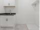 Functional laundry room with ample counter space, custom cabinets, and utility sink for added convenience at 267 Green Hill Rd, Sandy Springs, GA 30042