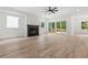 Spacious living room with a fireplace, large windows, and sliding doors to the outside deck at 267 Green Hill Rd, Sandy Springs, GA 30042