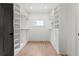 Spacious walk-in closet features custom shelving and drawers for optimal storage and organization solutions at 267 Green Hill Rd, Sandy Springs, GA 30042