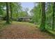 Backyard with a view of the home and lush trees at 408 Walnut Dr, Woodstock, GA 30189