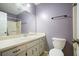 Cozy bathroom featuring a standard toilet, vanity with a sink, and a shower-tub combo at 408 Walnut Dr, Woodstock, GA 30189