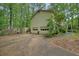 Exterior view of the side of the home with a driveway and garage doors at 408 Walnut Dr, Woodstock, GA 30189