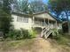 Charming home featuring a front porch and surrounded by lush greenery at 408 Walnut Dr, Woodstock, GA 30189