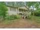 Charming home with a quaint front porch, complemented by lush landscaping and a welcoming walkway at 408 Walnut Dr, Woodstock, GA 30189