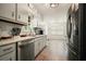 Bright kitchen with stainless steel appliances and wood-look vinyl floors at 408 Walnut Dr, Woodstock, GA 30189