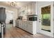 Updated kitchen featuring white cabinets, vinyl floors, and stainless appliances at 408 Walnut Dr, Woodstock, GA 30189