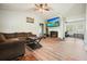 Comfortable living room features hardwood floors, fireplace, a ceiling fan, and access to other rooms at 408 Walnut Dr, Woodstock, GA 30189