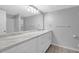 A modern bathroom with white vanity, double sinks, and a large mirror at 6851 Roswell Rd # C7, Atlanta, GA 30328