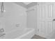 Bathroom featuring a tub and shower with tiled walls and updated fixtures at 6851 Roswell Rd # C7, Atlanta, GA 30328