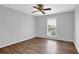 Bright bedroom with a ceiling fan, a window with blinds, and neutral walls at 6851 Roswell Rd # C7, Atlanta, GA 30328
