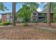 Charming two-story building featuring Tudor-style architecture nestled amongst mature trees at 6851 Roswell Rd # C7, Atlanta, GA 30328