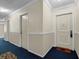 Hallway features neutral walls, white trim, blue carpet, and doorways leading to rooms at 6851 Roswell Rd # C7, Atlanta, GA 30328