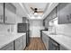 Stylish kitchen with stainless steel appliances, sleek countertops, and ample storage space in gray cabinets at 6851 Roswell Rd # C7, Atlanta, GA 30328