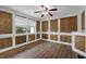Cozy living room with decorative wood paneling, hardwood floors, and a ceiling fan at 6851 Roswell Rd # C7, Atlanta, GA 30328