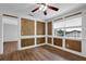 Comfortable living room with decorative wood paneling, hardwood floors, and a ceiling fan at 6851 Roswell Rd # C7, Atlanta, GA 30328