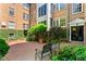 Serene courtyard with lush greenery, brick paving, and outdoor seating at 8 Collier Nw Rd # A1, Atlanta, GA 30309