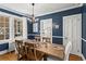 Dining room with blue walls, wooden table, chandelier, and natural light at 8 Collier Nw Rd # A1, Atlanta, GA 30309