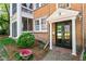 Charming brick home with a black front door and manicured landscaping at 8 Collier Nw Rd # A1, Atlanta, GA 30309