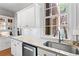 Bright kitchen features white cabinets, granite countertops, stainless steel appliances, and a large window at 8 Collier Nw Rd # A1, Atlanta, GA 30309