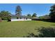 Expansive backyard with a large grassy area, mature trees, and a wooden fence, perfect for outdoor activities at 8449 Kendrick Rd, Jonesboro, GA 30238