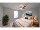 Cozy bedroom featuring a ceiling fan, soft rug, neutral walls, and comfortable bed with bright bedside lamps at 8449 Kendrick Rd, Jonesboro, GA 30238
