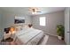 Relaxing bedroom with a ceiling fan, natural light from a window, and a comfortable bed with stylish lamps at 8449 Kendrick Rd, Jonesboro, GA 30238