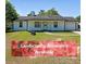 Charming one-story home with a fresh white exterior, black trim, and front yard with landscaping allowance at 8449 Kendrick Rd, Jonesboro, GA 30238