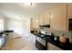 Well-lit kitchen featuring modern appliances, granite countertops, and ample cabinetry at 8449 Kendrick Rd, Jonesboro, GA 30238