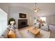 Inviting living room with a brick fireplace, comfortable seating, and plenty of natural light, virtually staged at 8449 Kendrick Rd, Jonesboro, GA 30238