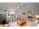 Bright, virtually staged living room featuring high ceilings, a fireplace, and a view of the dining area and bedroom at 8449 Kendrick Rd, Jonesboro, GA 30238