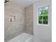 Bright tiled bathroom with tiled shower, and bright window views at 1322 Thurgood Sw St, Atlanta, GA 30314