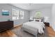 A bedroom with two windows, neutral colors, and light hardwood floors at 1322 Thurgood Sw St, Atlanta, GA 30314