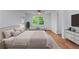 Bright bedroom with natural light, ceiling fan, hardwood floors, and a comfortable seating area at 1322 Thurgood Sw St, Atlanta, GA 30314