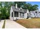 Quaint home with brick facade, landscaped front yard, and a long driveway at 1322 Thurgood Sw St, Atlanta, GA 30314