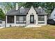 Quaint home with brick facade, landscaped front yard, and mature trees at 1322 Thurgood Sw St, Atlanta, GA 30314