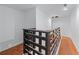 Second floor hallway with wood railing and hardwood floors at 1322 Thurgood Sw St, Atlanta, GA 30314